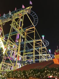 Low angle view of ferris wheel at night