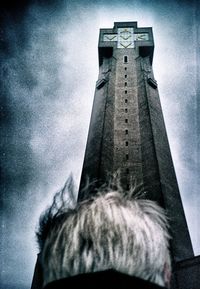 Low angle view of statue on tower against sky