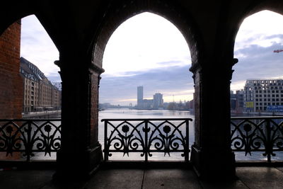 View of city buildings against cloudy sky