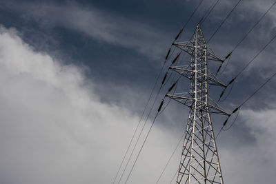 Low angle view of electricity pylon against sky