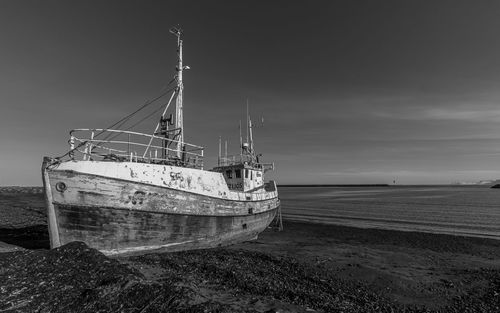 Full frame view of an old boat run aground on a beach