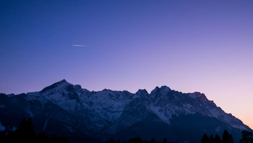 Scenic view of mountains against clear blue sky at night
