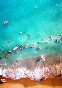 High angle view of people swimming in sea