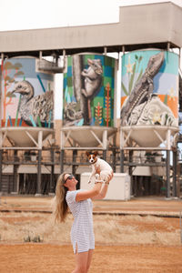 Side view of young woman using phone