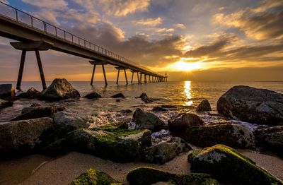 Low angle view of bridge on calm sea