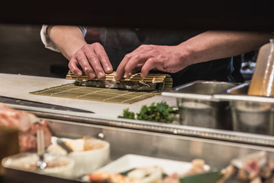 Midsection of man preparing food