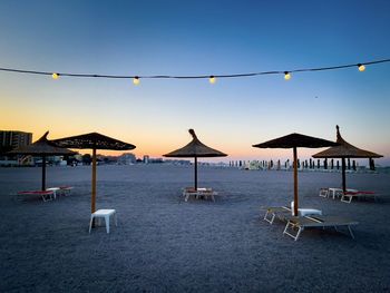 Sunbeds and umbrellas on the empty beach in the evening