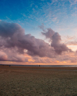 Scenic view of beach against sky during sunset