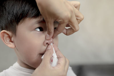 Close-up portrait of boy with hands