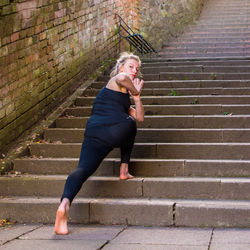 High angle view of young woman standing on steps