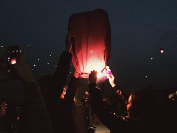 View of illuminated firework display at night