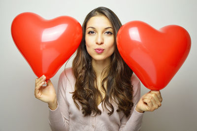 Portrait of woman with heart shape balloon