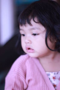 Close-up portrait of cute girl looking away