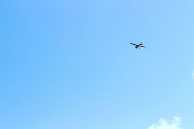 Low angle view of airplane flying in sky