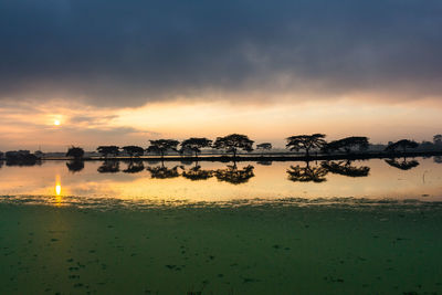 Scenic view of lake against orange sky