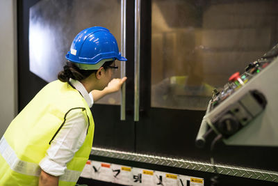 Rear view of man working in factory