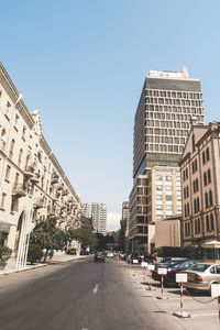 Street amidst buildings against sky in city