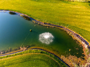 High angle view of canal amidst field