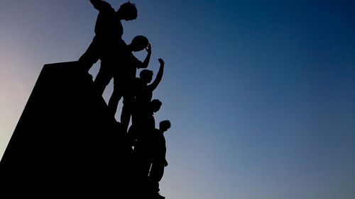 Low angle view of silhouette against clear sky