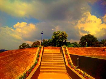 Empty staircase against sky during sunset