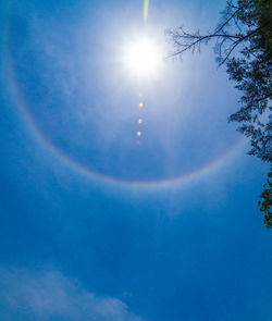 Low angle view of rainbow against blue sky