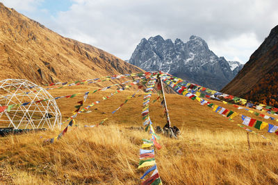 Autumn landscape with tibetan prayer flags on foreground. scenic view in the caucasus mountains. 