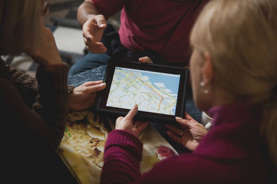 People looking at map on digital tablet