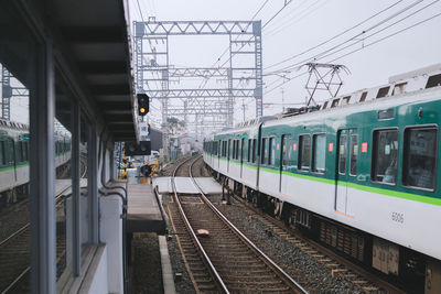 Train at railroad station against sky