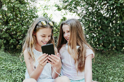 Portrait of a smiling young woman using mobile phone