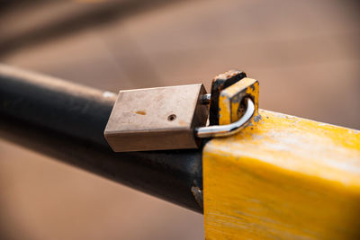 Close-up of rusty padlock on rod