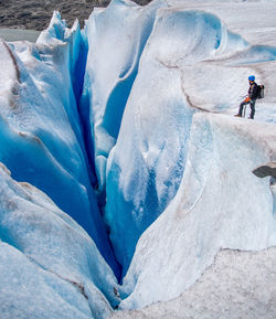 People walking on snow covered landscape