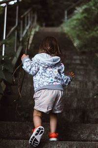 Rear view of girl standing outdoors