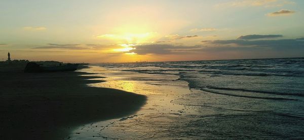 Scenic view of beach against sky during sunset