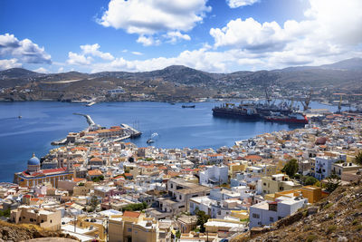 High angle view of townscape by sea against sky