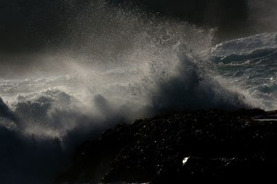Close-up of waves splashing on rocks in sea