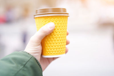 Close-up of hand holding ice cream cone