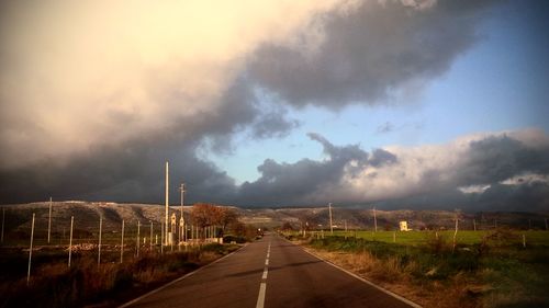 Road amidst landscape against sky