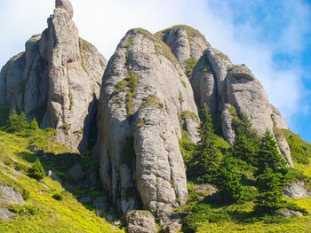 Low angle view of rock formation against sky