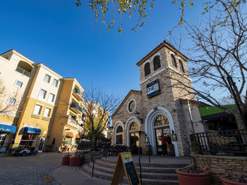 Low angle view of buildings against clear blue sky