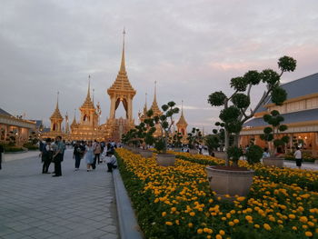 People at temple against sky