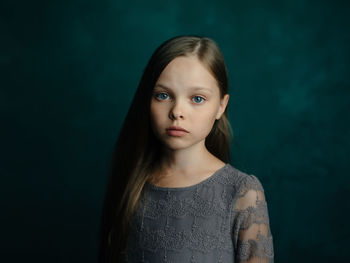 Portrait of woman against black background