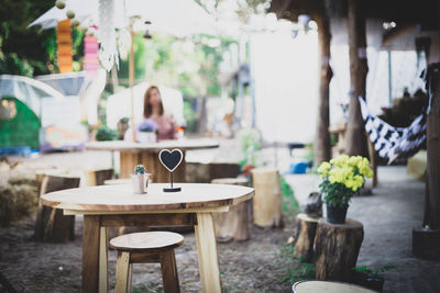 Empty chairs and tables at sidewalk cafe