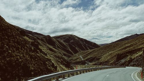 Road amidst mountains against sky