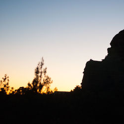 Low angle view of silhouette trees against sky during sunset