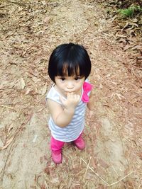 High angle portrait of cute girl standing on field