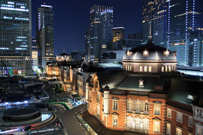 High angle view of city lit up at night