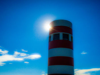 Low angle view of lighthouse against blue sky