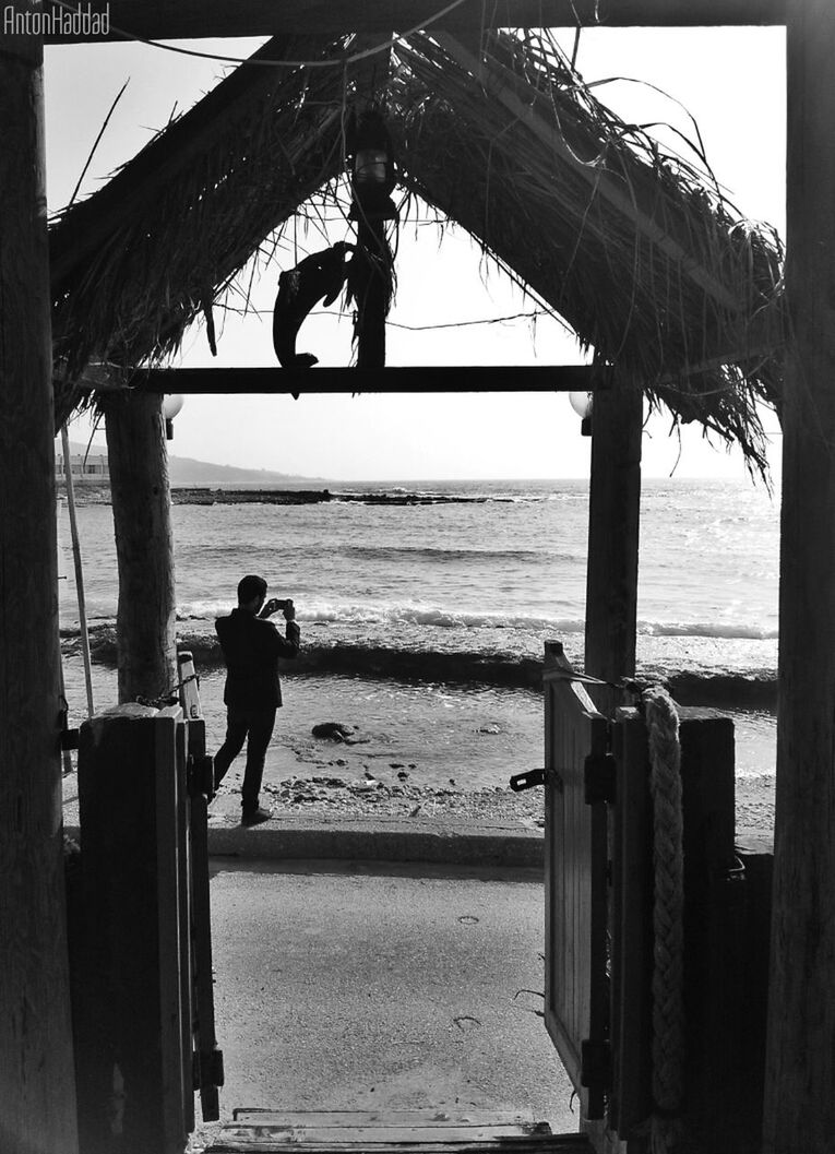 WOMAN STANDING ON BEACH