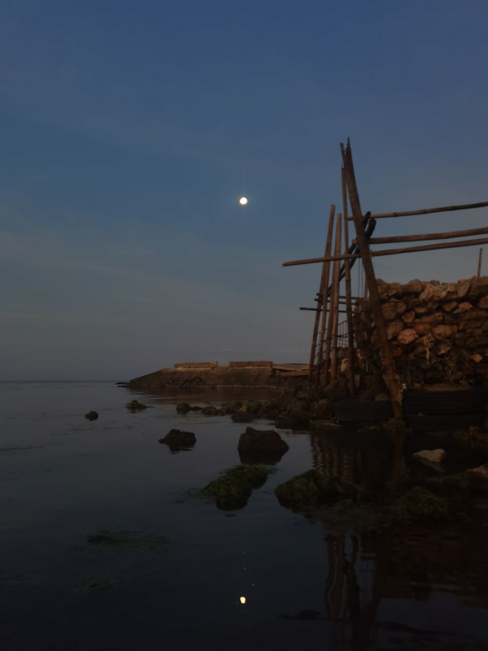 moon, sky, water, sea, ocean, reflection, nature, coast, evening, beauty in nature, no people, tranquility, scenics - nature, dusk, horizon, tranquil scene, full moon, night, land, architecture, sunset, built structure, outdoors, beach, light, moonlight, rock, shore, horizon over water