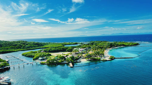 High angle view of townscape by sea against sky